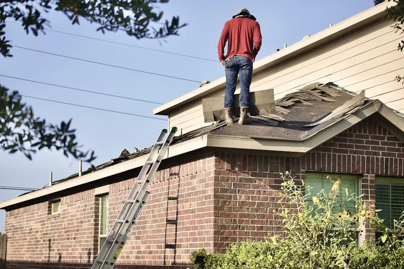 Professional roofer working on a residential roof in Startex
